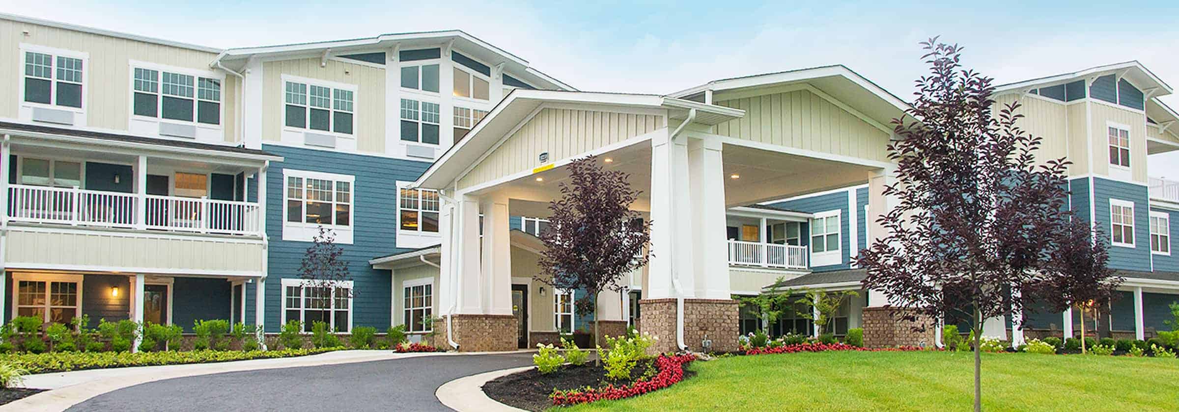 A blue and white building on the Traditions Management senior living campus