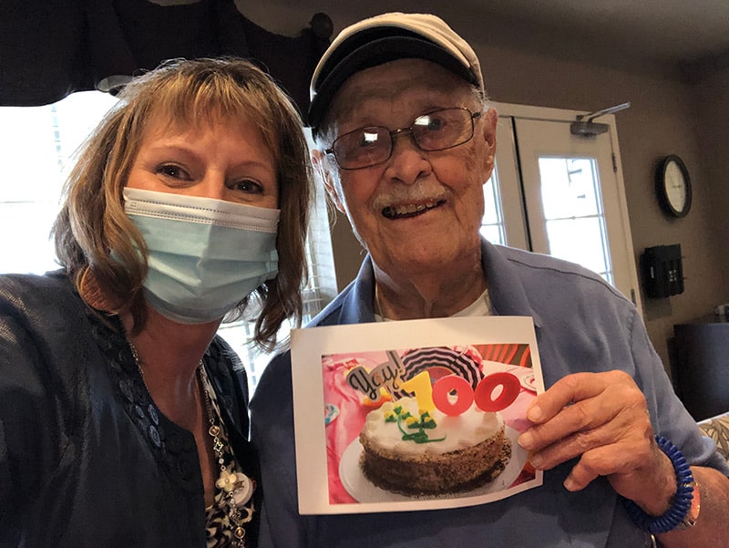 Bill takes a selfie with a younger lady celebrating his 100th birthday